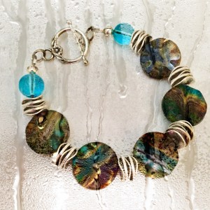 Czech glass coin beads in a sand and Aqua color, Sandy Beach, with a Picasso finish combined with silver tone disks. 2 are available, one with a toggle clasp, the other with a lobster clasp. Please contact me as to which you would like. 7